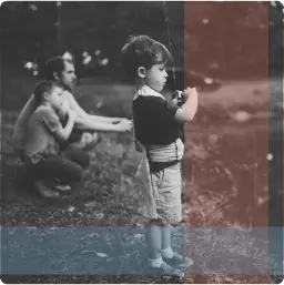 Young boy casting fishing line; father and sibling watch