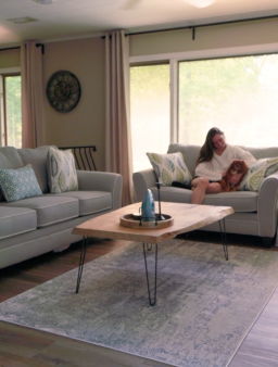 Bright living-room seating area with grey sofas and coffee table